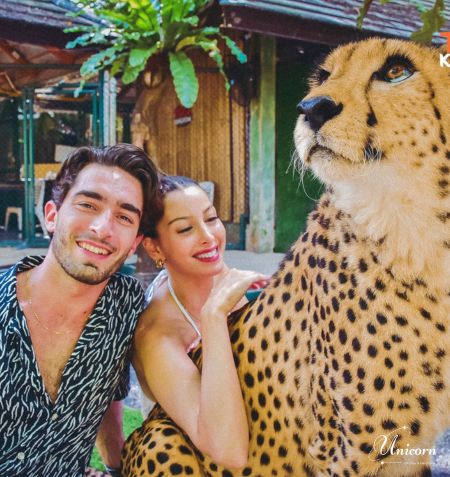 Happy couple enjoying a cheetah encounter experience in Phuket