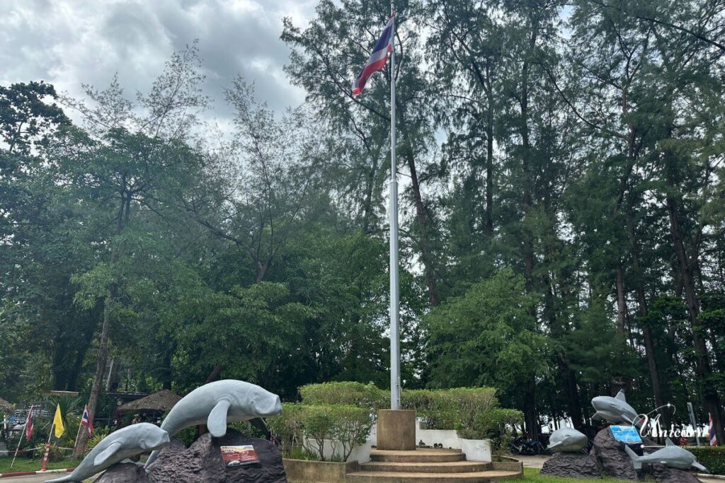 Private Transfer from Phuket to Ao Nang Beach – Fixed Price & Door-to-Door 6 Dugong monument at Ao Nang Beach park surrounded by pine trees